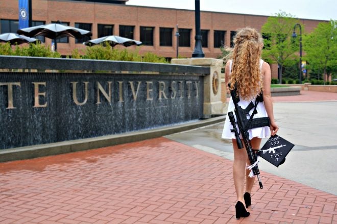 Her Graduation Photos Brought Death Threats — Because She Had a Gun
