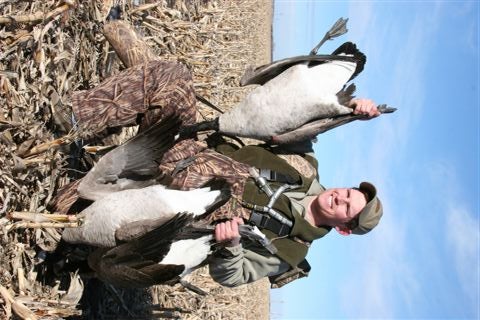 Tyson Keller holds part of a four-man daily limit of Canada geese taken near Pierre, South Dakota.