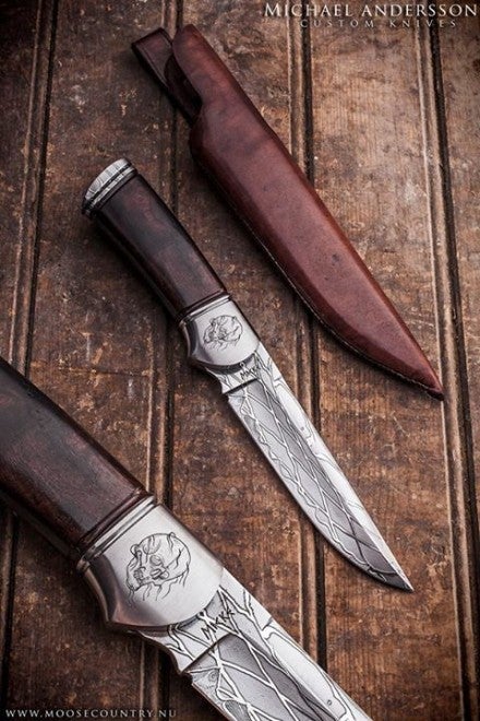 From Andersson's FB page: "This knife has a handle made from Desert Iron Wood. The but cap is Web Mosaic, engraved stainless steel bolster. The blade is San-Mai construction Web Mosaic with a cord forged from Twist Damascus. And of course handmade leather sheath."