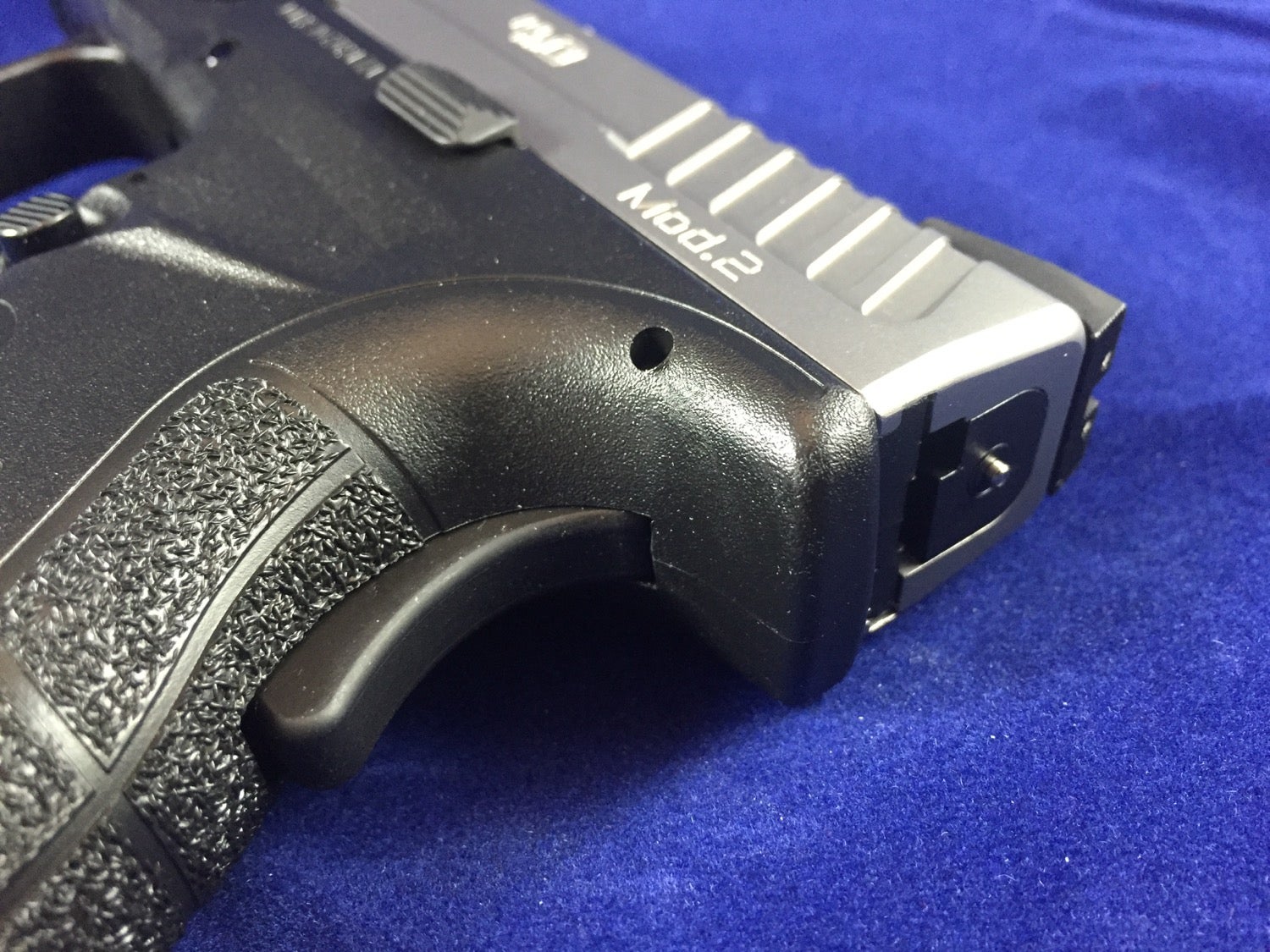 Rear grip safety and striker status indicator.