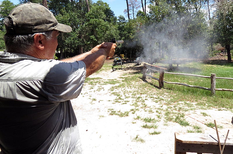 George Halstead fires a blank from his prototype pistol. Photo © Russ Chastain