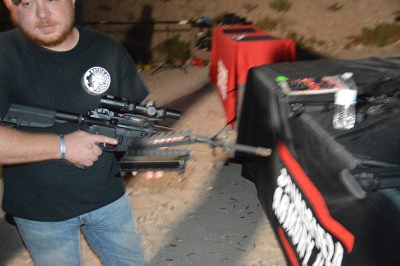 Patrick R. with his melted off handguards. Note the color change on the flash hider from burning off the finish.