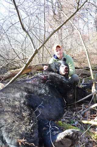 Jason Burns poses with Dustin Learn's huge Pennsylvania black bear. 