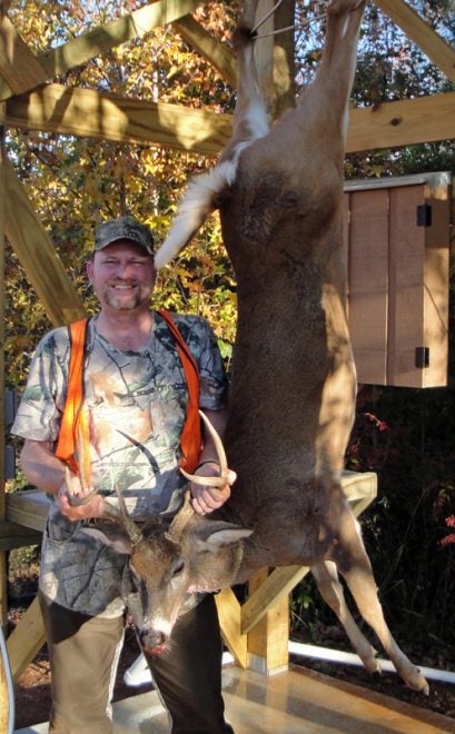 My buck and me at the skinning shed. (Photo © Russ Chastain) 