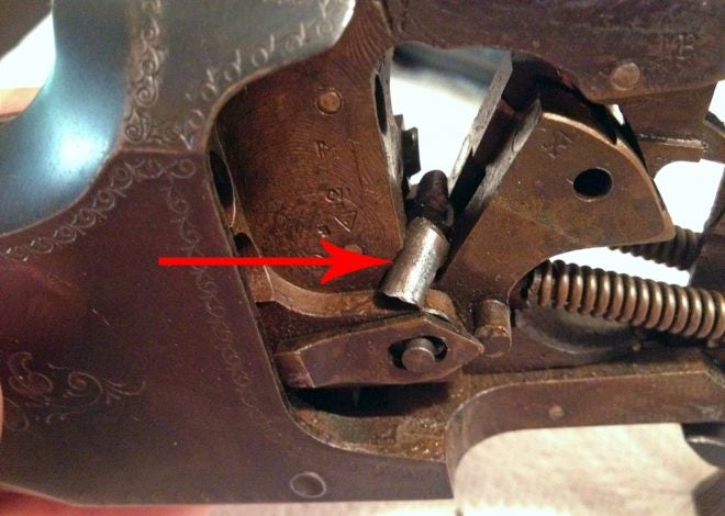 The arrow shows part of the broken firing pin blocking the hammer. I hate it when that happens! (Photo © Russ Chastain) 