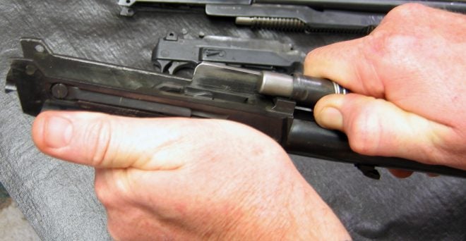 Removing Ruger Carbine action spring, slide, and magazine tube assembly. (photo © Russ Chastain) 