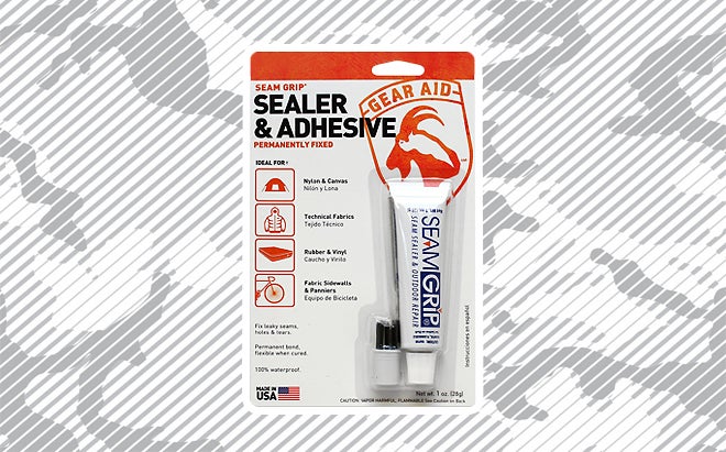 Gear Aid seam sealer and outdoor repair sealer and adhesive on urban camo background