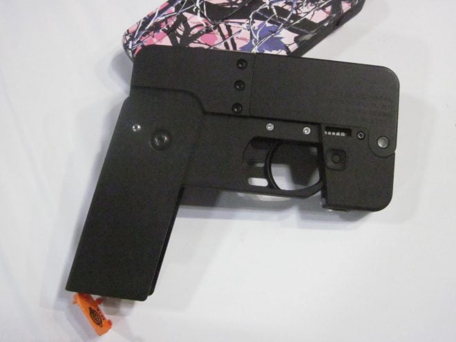 Cell Phone Pistol ready to fire. Note the brightly patterned prototype in the background.
