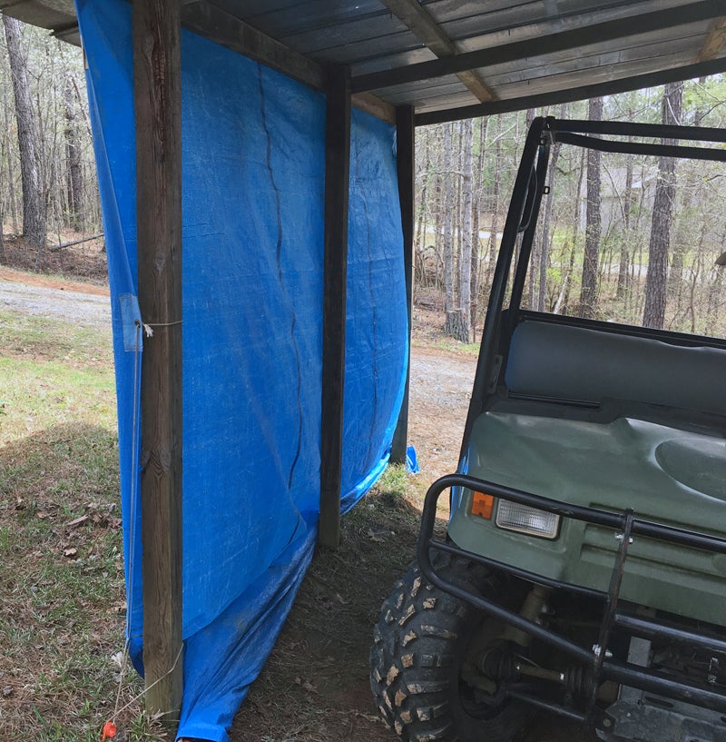 Tarp anchored with Orange Screw ground anchors.