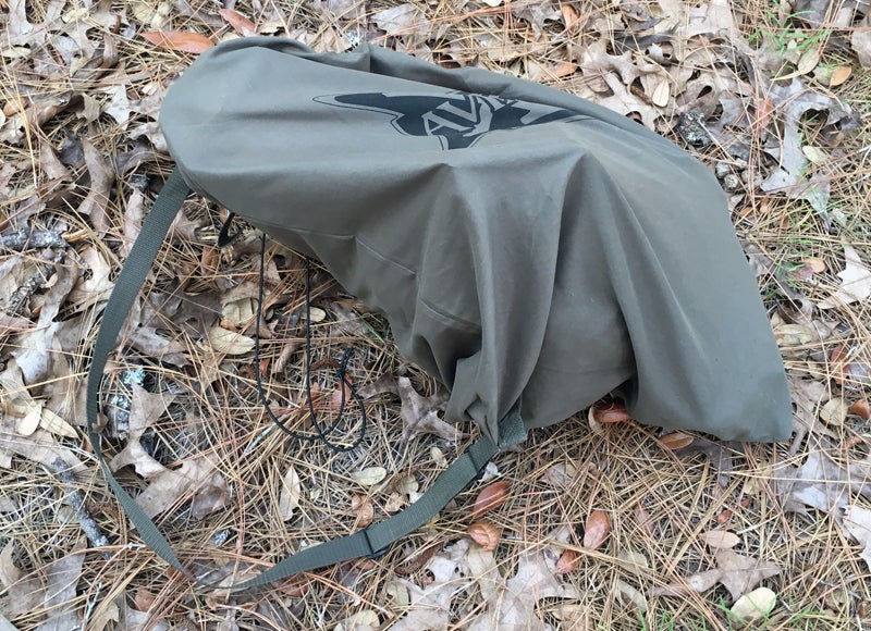 The large green tote bag has an elastic drawstring and shoulder/hand strap.