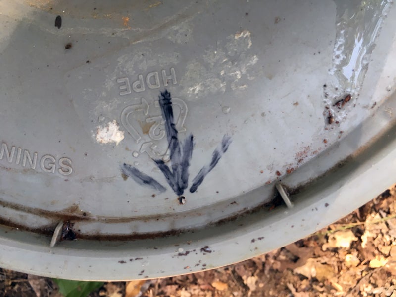 Arrow points to a tiny hole I bored through this bucket lid. (Photo © Russ Chastain)