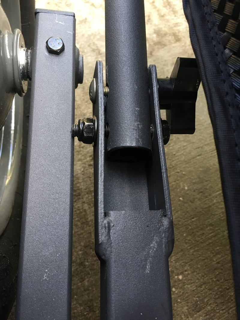 I had to add the bolt with knob (one per side). The provided bolt was so long it interfered with the axle holding piece. Reversing the bolt would have allowed the threaded end to interfere with the knob. (Photo © Russ Chastain)