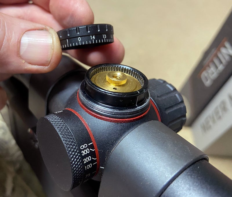 Lift the turret knob straight off. Then put it back on with the zero mark aligned. Reinstall the screw, and you're done. (Photo © Russ Chastain)