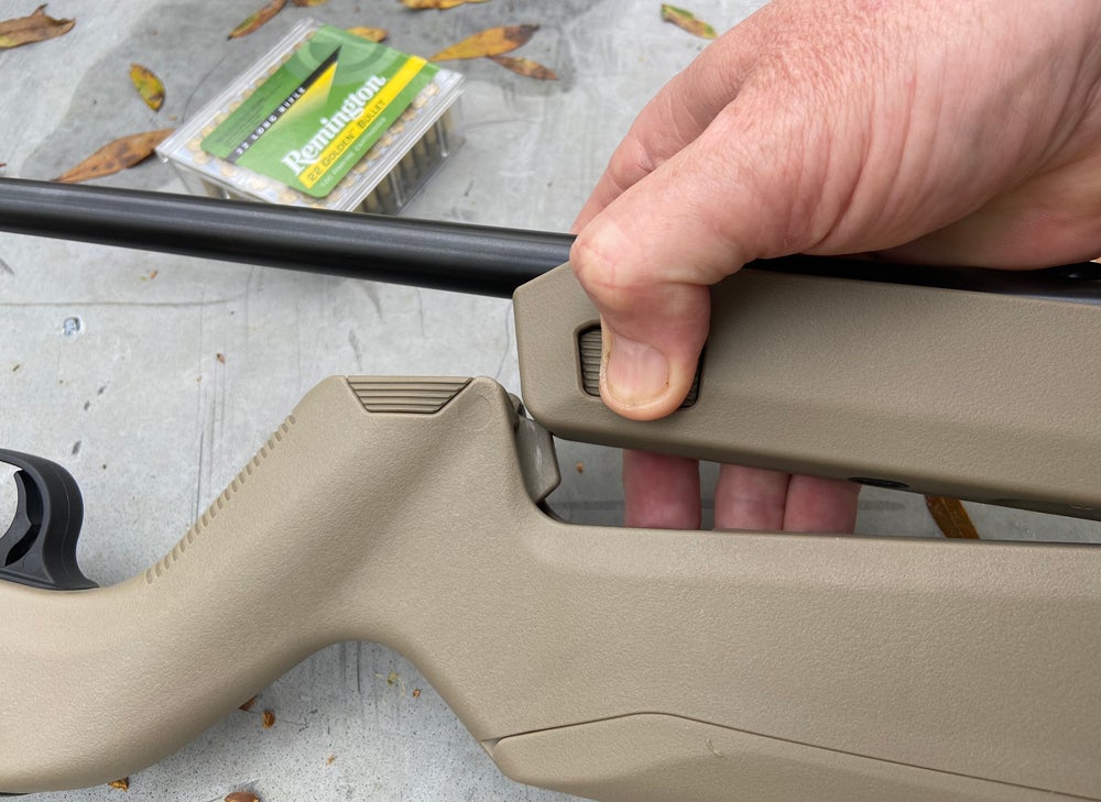To remove the barrel & forend, squeeze the buttons on the sides to release it from the butt stock, then pivot it away from the butt stock. (Photo © Russ Chastain)
