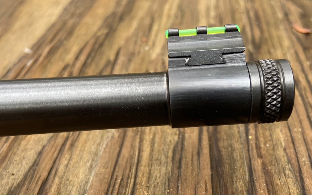 Front sight is dovetailed in place. Muzzle is threaded and comes with this knurled thread protector. (Photo © Russ Chastain)
