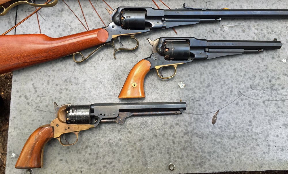 Uberti revolving carbine (top), Remington-style revolver, Colt-style revolver (bottom). (Photo © Russ Chastain)
