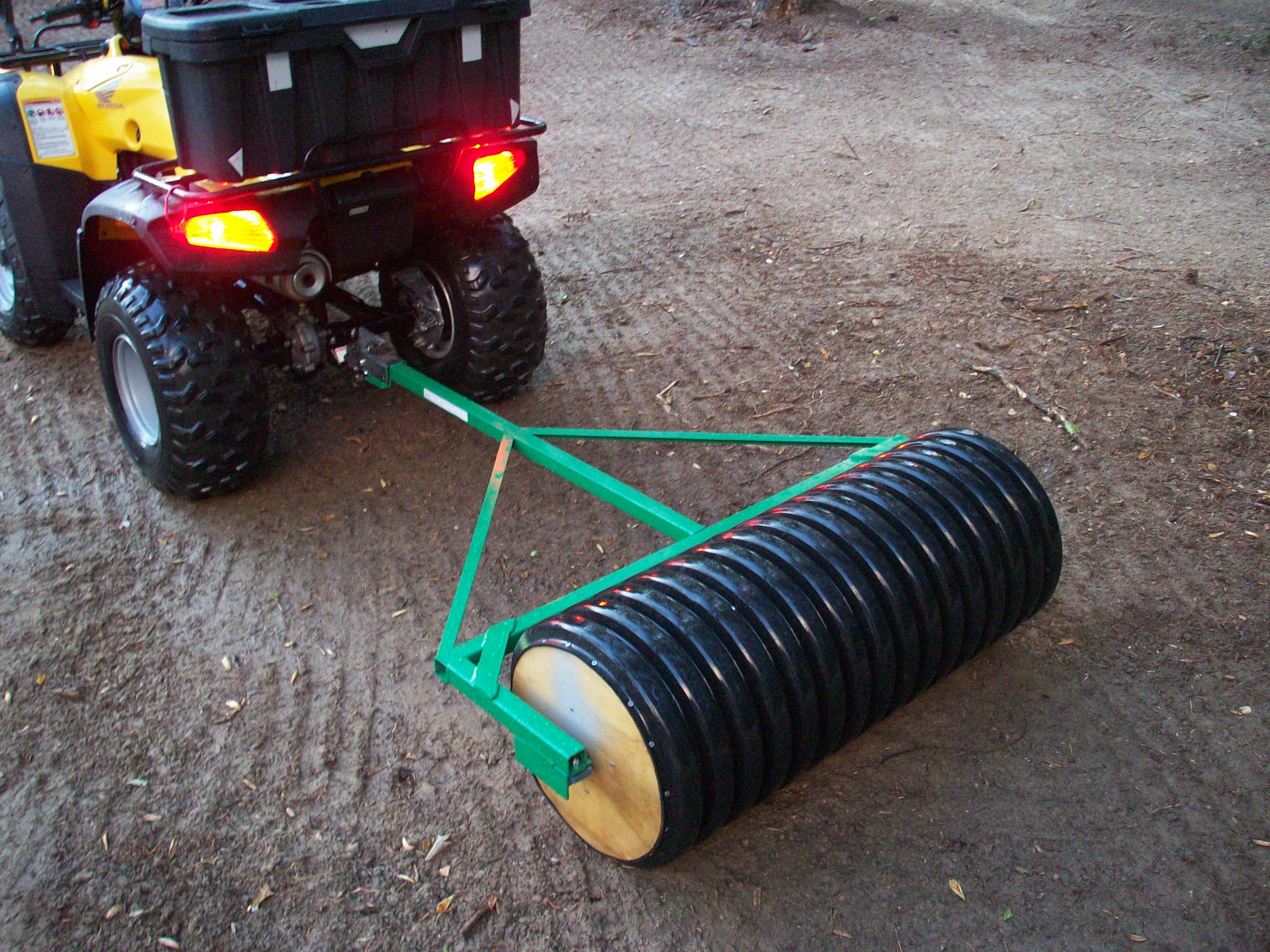 This homemade cultipacker is concrete-filled plastic drain pipe with a steel axle & bearings.