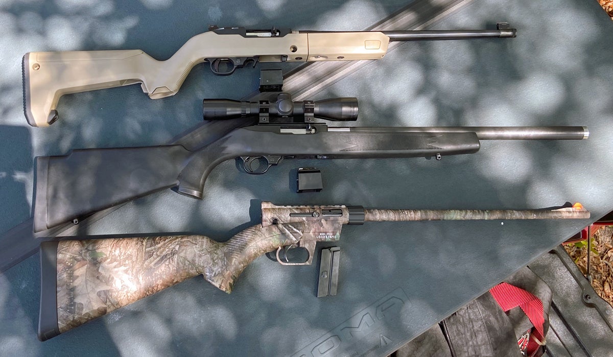 A trio of 22s. Top to Bottom: Ruger 10/22 Backpacker Takedown, Ruger 10/22 with Butler Creek stock & barrel, Henry US Survival AR-7. (Photo © Russ Chastain)