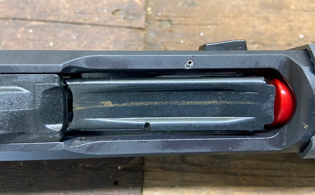 Brass marks on the shell elevator and a ding from a roll pin punch. (Photo © Russ Chastain)