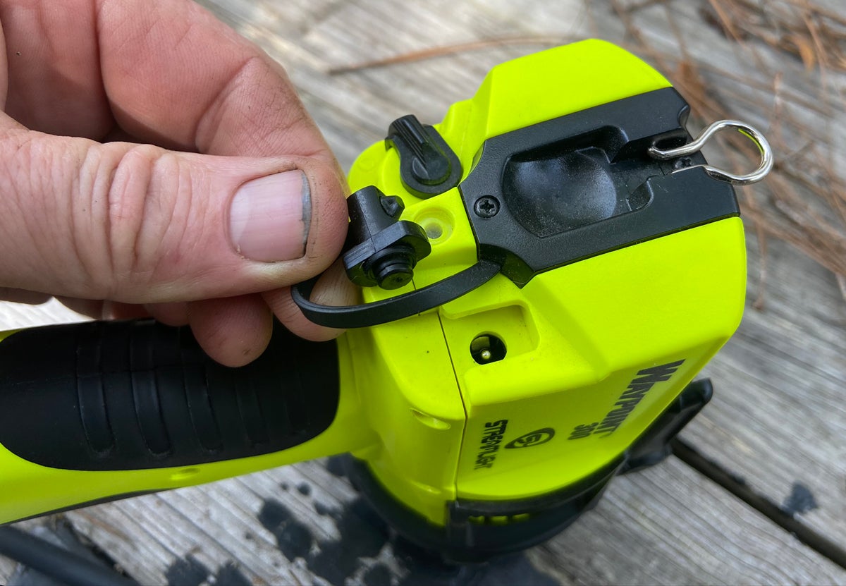 Tethered peg covers the charging port and this is as far as the hanging eye unfolds. Please forgive the tractor grease under my thumbnail. (Photo © Russ Chastain)