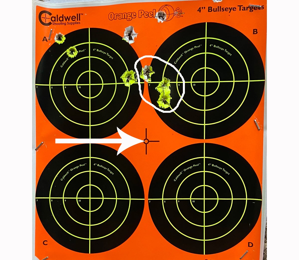 A 1-1/8" 3-shot group at 150 yards? Yes, thanks. Arrow indicates point of aim. (Photo © Russ Chastain)