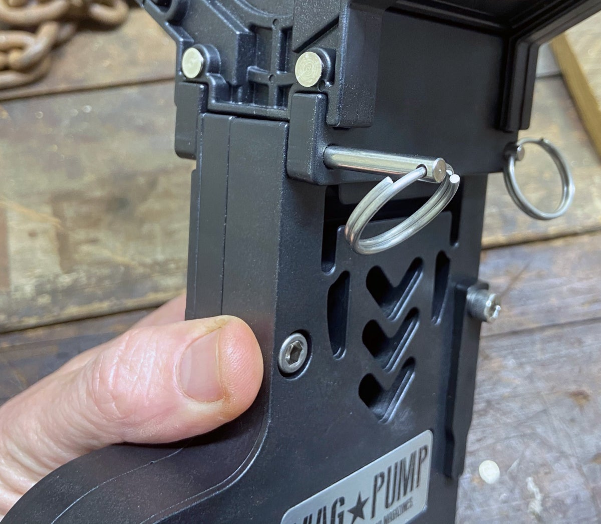 Inserting the pins to hold hopper on loader (Photo © Russ Chastain)