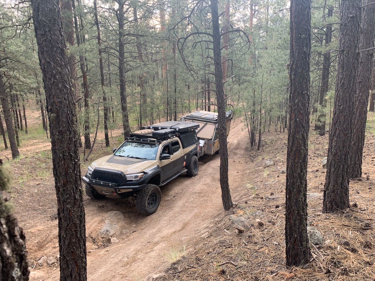 truck pulling a trailer on a remote trail